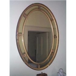 A LATE VICTORIAN GILTWOOD AND, GILT-COMPOSITION OVAL PIER GLASS, circa 1890, with reeded inner sli..