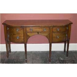 A LATE GEORGE III EBONY-INLAID MAHOGANY BOWFRONT SIDEBOARD, LATE 18th CENTURY, the shaped top above.