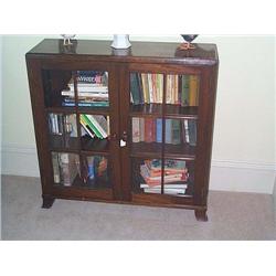 A MAHOGANY SIDE CABINET, EARLY 20th, CENTURY, with glazed doors enclosing two shelves, on splayed...