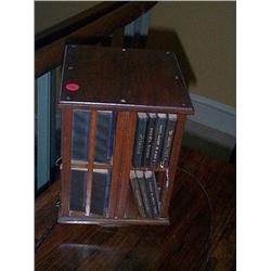 A SMALL SQUARE REVOLVING BOOKCASE,, 20th CENTURY, containing the works of Shakespeare., (a lot)<...