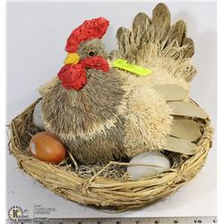 CHICKEN SITTING ON EGGS IN NEST