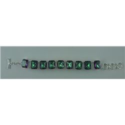 270CT MYSTIC TOPAZ BRACELET. 9 EMERALD CUT TOPAZES. TOGGLESTYLE. RETAIL VALUE $400