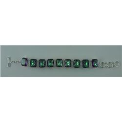 270CT MYSTIC TOPAZ BRACELET. 9 EMERALD CUT TOPAZES. TOGGLESTYLE. RETAIL VALUE $400