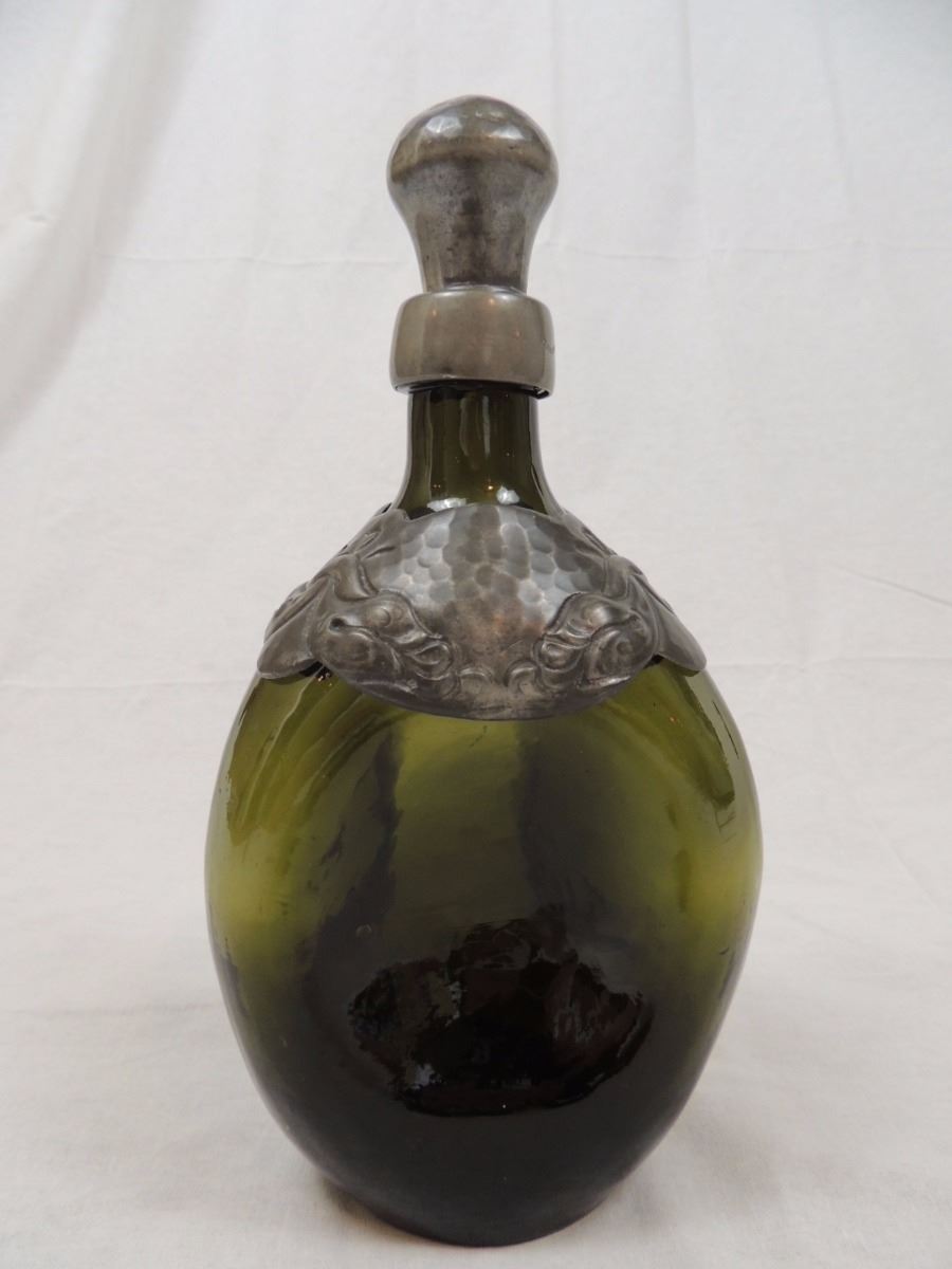 Green glass pinch bottle decanter with pewter