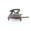 Image 2 : Collection of 3 antique sad irons 2 on trivets includes small childs toy 3" long.