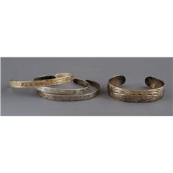Four Northwest Coast Silver Bracelets; Kwakiutl Wolf Design signed P.W. 5 1/2" L. 1/2" W. and Three 