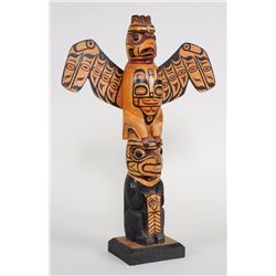 Kwakwaka'wakw Totem Carved with Thunderbird and Bear Holding a Copper 13 1/2" H. 9 1/2" W.