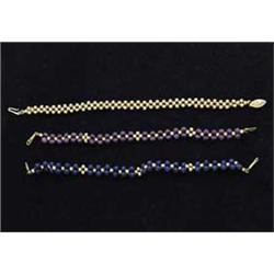 THREE GOLD & GEMSTONE BRACELETS
