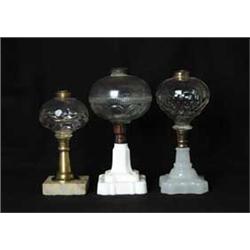 THREE PRESSED GLASS OIL LAMPS