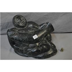 Large Inuit soapstone of a man and a fish, signed and numbered on base, 12  in length and 8 1/2  in 