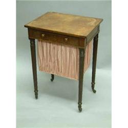 A Regency mahogany work table with frieze drawer and pull out basket on reeded tapered legs with...