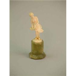 A carved ivory figure of a lady with billowing skirt, on green ivory socle (a.f.) 4.5ins...