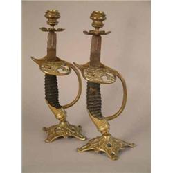 A pair of Victorian brass mounted Prussian sword hilt candlesticks 12in....