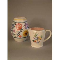 A Poole pottery vase with floral decoration 8.25in., and a jug 5.5in....