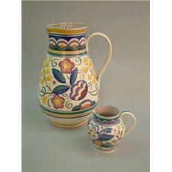 A large Poole pottery jug, with floral decoration, 14ins (cracked) and a similar jug, 5.5ins...