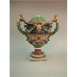 A Continental majolica Cellini-esque urn with caryatid handles, on square foot, 21 ins. (a.f)...