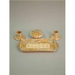 A Charlotte Rhead Bursley ware four piece dressing table set, decorated with flowers...