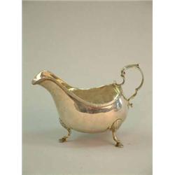 A George III Irish silver sauceboat, with scroll handle and pad feet, Makers initials MW Dublin 1...