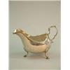 Image 1 : A George III Irish silver sauceboat, with scroll handle and pad feet, Makers initials MW Dublin 1...