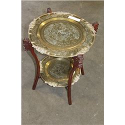 FOLDING CARVED MAHOGANY TABLE WITH TWO ORNATE BRASS TRAYS