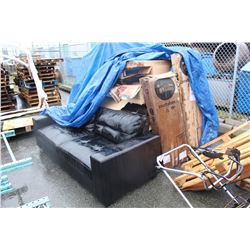 PILE OF FURNITURE UNDER BLUE TARP