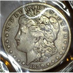 1899 O U.S. Morgan Silver Dollar in a Littleton Coin Company holder, Fine.