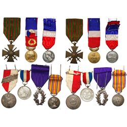 Lot of seven base-metal French medals (breast badges) with ribbons, 1901-1977.