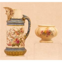 A Royal Worcester mask spout cylindrical jug, blush ivory ground with blue and gilt handle and bo...