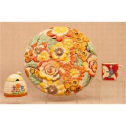 A Clarice Cliff Wilkinson Ltd nursery ware coffee cup, the orange/red ground painted with a white...