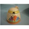 A Clarice Cliff, Newport Pottery, Crocus pattern honey pot beehive (minute paint chip to base)....