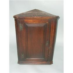 An 18thC, Oak wall hanging corner cabinet, 20" wide x 29" high....