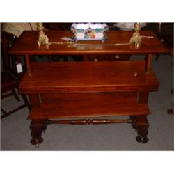 Une desserte métamorphique en acajou, vers 1840, de forme rectangulaire à trois plateaux, elle es...