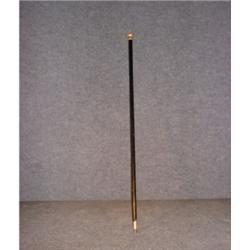 Une canne en ébène à poignée de métal doré.  An ebony cane with a gilt metal grip. $100/150...