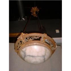 Une suspension en albâtre dans une monture en bronze doré retenue par 3 tiges gainées de passemen...