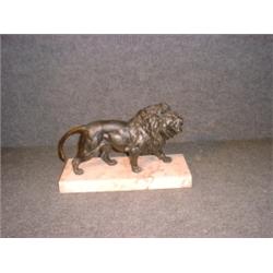 Un sujet en bronze patiné représentant un lion.  A patinated bronze figure of a lion. $500/700...