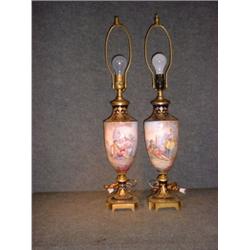 Une paire d'urnes en porcelaine dans le goût de Sèvres à décor de pastorales sur un fond bleu cob...