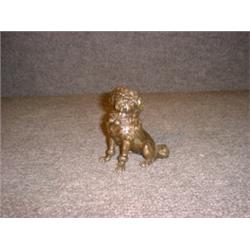 Un sujet en bronze patiné représentant un caniche.  A patinated bronze figure of a poodle. $325/3...
