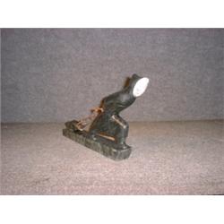 Une sculpture inuit en stéatite représentant un chasseur traînant un phoque, signé: "Emil Socher,...