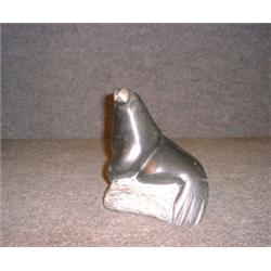 Une sculpture inuit en stéatite représentant un phoque, signé: "Henry"....