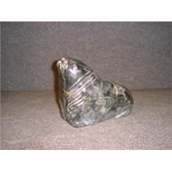 Une sculpture inuit en stéatite représentant un morse.  An Inuit stone carving of a walrus. $250/...