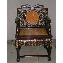 Un fauteuil chinois, le dossier ajouré orné d'une plaque circulaire en marbre rose, le siège en m...