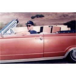 ANDREW BUSH (B. 1957) UNTITLED (MAN IN PINK CONVERTIBLE) COLOR PHOTOGRAPH MOUNTED ON PLEXIGLAS 27...