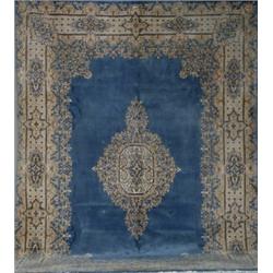 Kerman Rug, Post 1950, Blue ground centering a pulled medallion on beige ground enclosing flo...