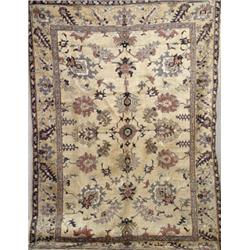 Oushak Rug, First Quarter 20th Century, Beige ground with a rosette and palmette field on var...