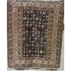 Caucasian Rug, Circa 1900, Blue ground with a geometric field within a latchhook and rosette...