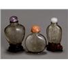 Image 1 : Group of Three Chinese Hardstone, Snuff Bottles, 19th Century, Consisting of a smoky quartz...