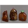 Image 1 : Group of Three Chinese Amber Snuff Bottles, 19th Century, The first, carved as a figure sitti...