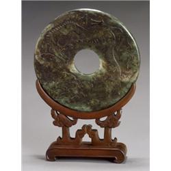 Chinese Russet Spinach-Green Jade Large Bi Disc, 20th Century, Carved to depict a dragon in p...