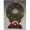 Image 1 : Chinese Russet Spinach-Green Jade Large Bi Disc, 20th Century, Carved to depict a dragon in p...