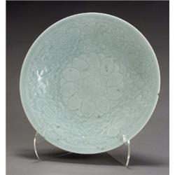 Chinese Celadon Glazed Charger, 19th Century, The interior carved with lotus scrolls. Some gl...